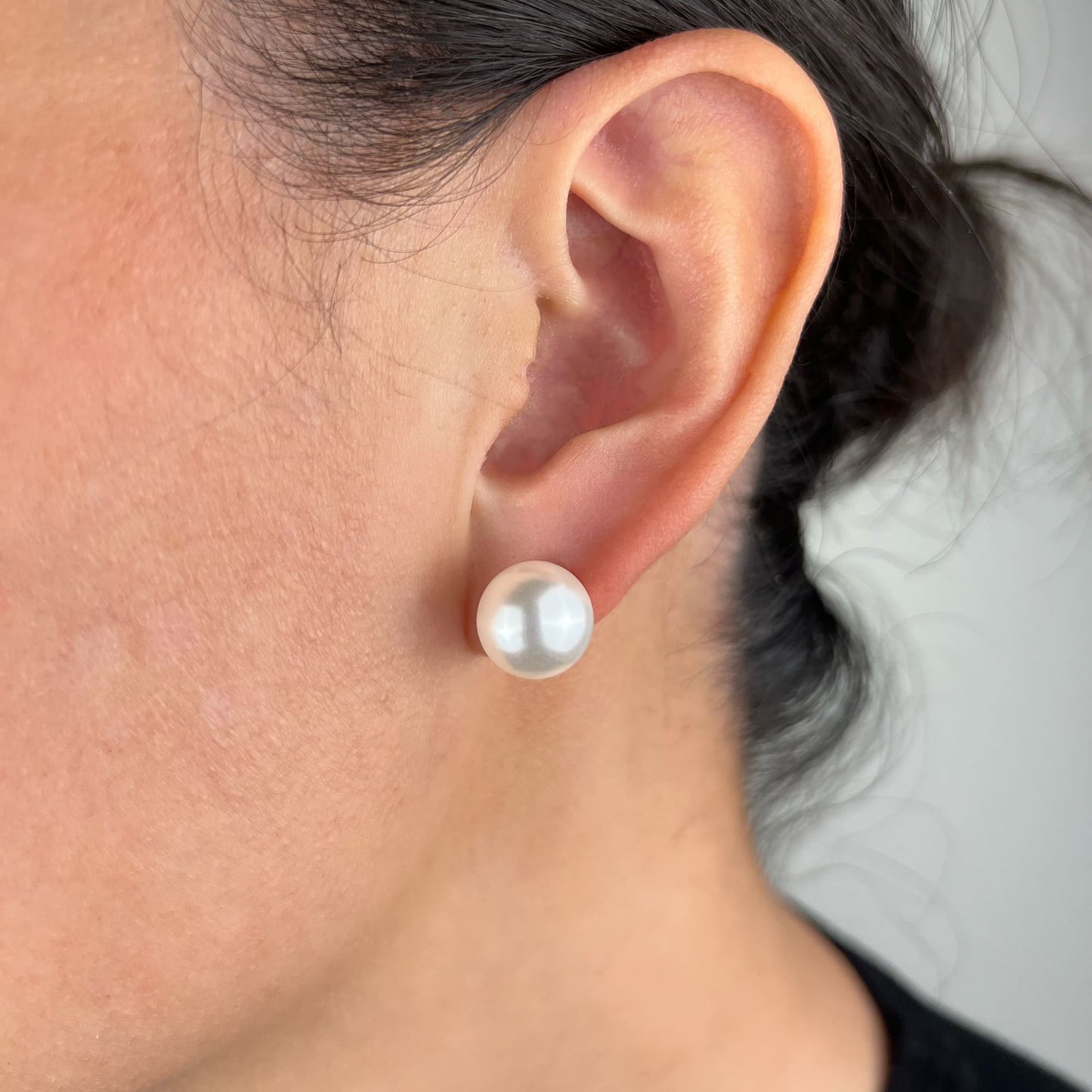 Model showcasing timeless style with 12mm White Pearl Stud Earrings - Elegant and versatile jewelry for a classic and sophisticated look.