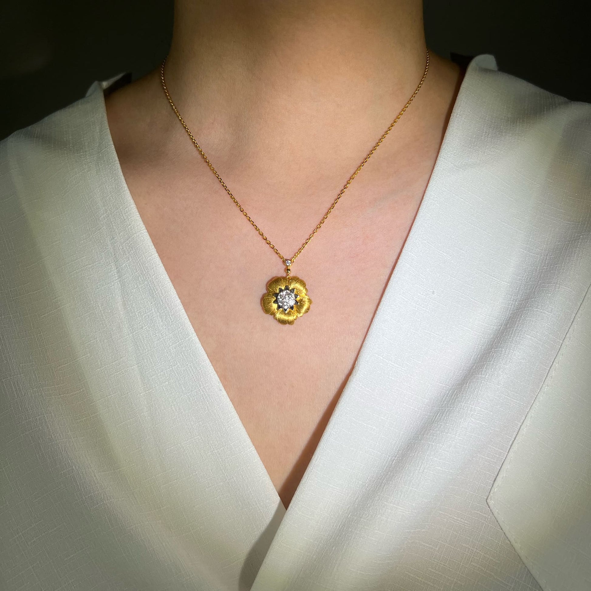 Model adorned with the Blossom Necklace - Showcasing timeless elegance and meticulous craftsmanship with the rigato technique for a unique and sophisticated look.