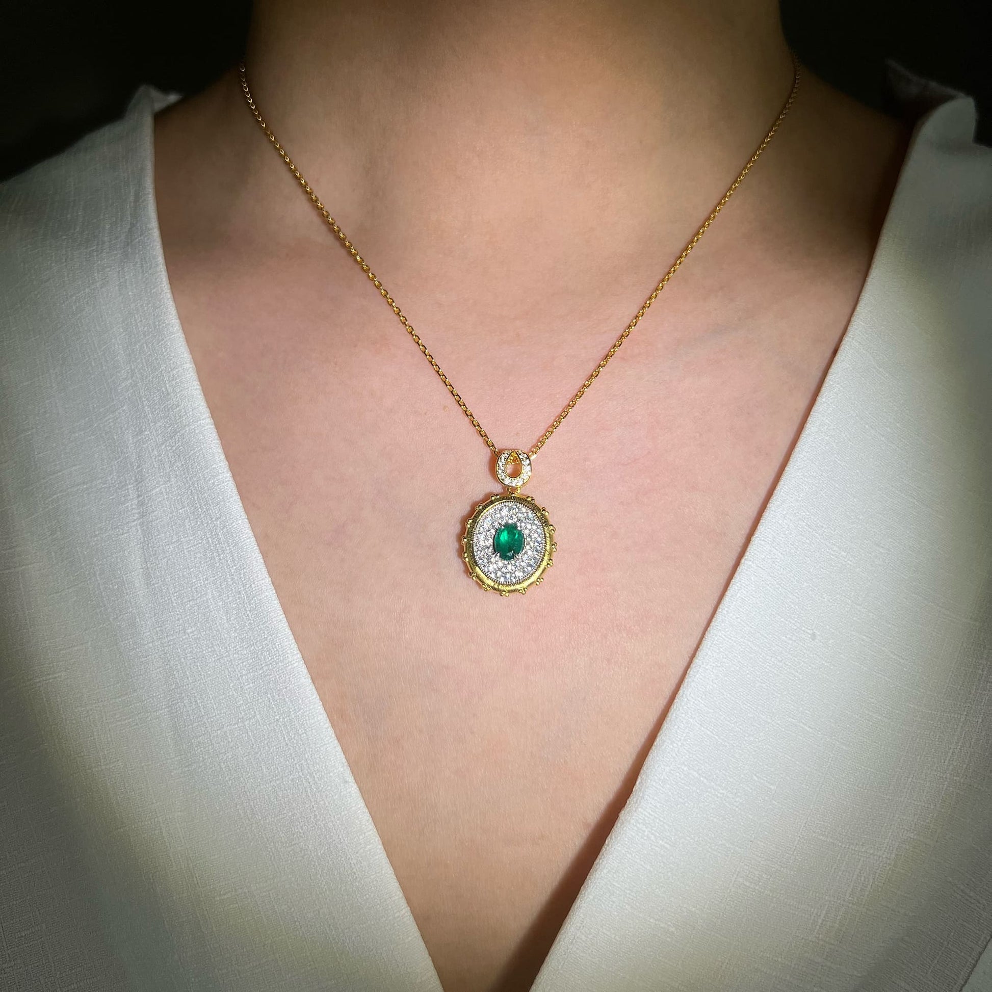 Model displaying the simulated emerald side of the Double-Sided Quatrefoil Necklace - Versatile elegance with the unique ability to switch looks effortlessly, adding sophistication and timeless charm to any occasion.