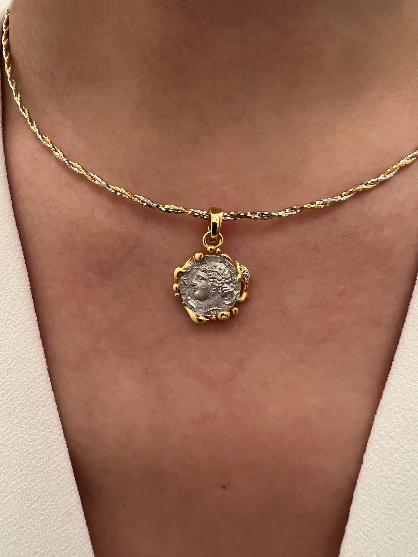 Close-up of the Nymph Arethusa Coin Pendant paired with a dual-tone gold and silver choker, showcasing the necklace's sophisticated style and versatility.