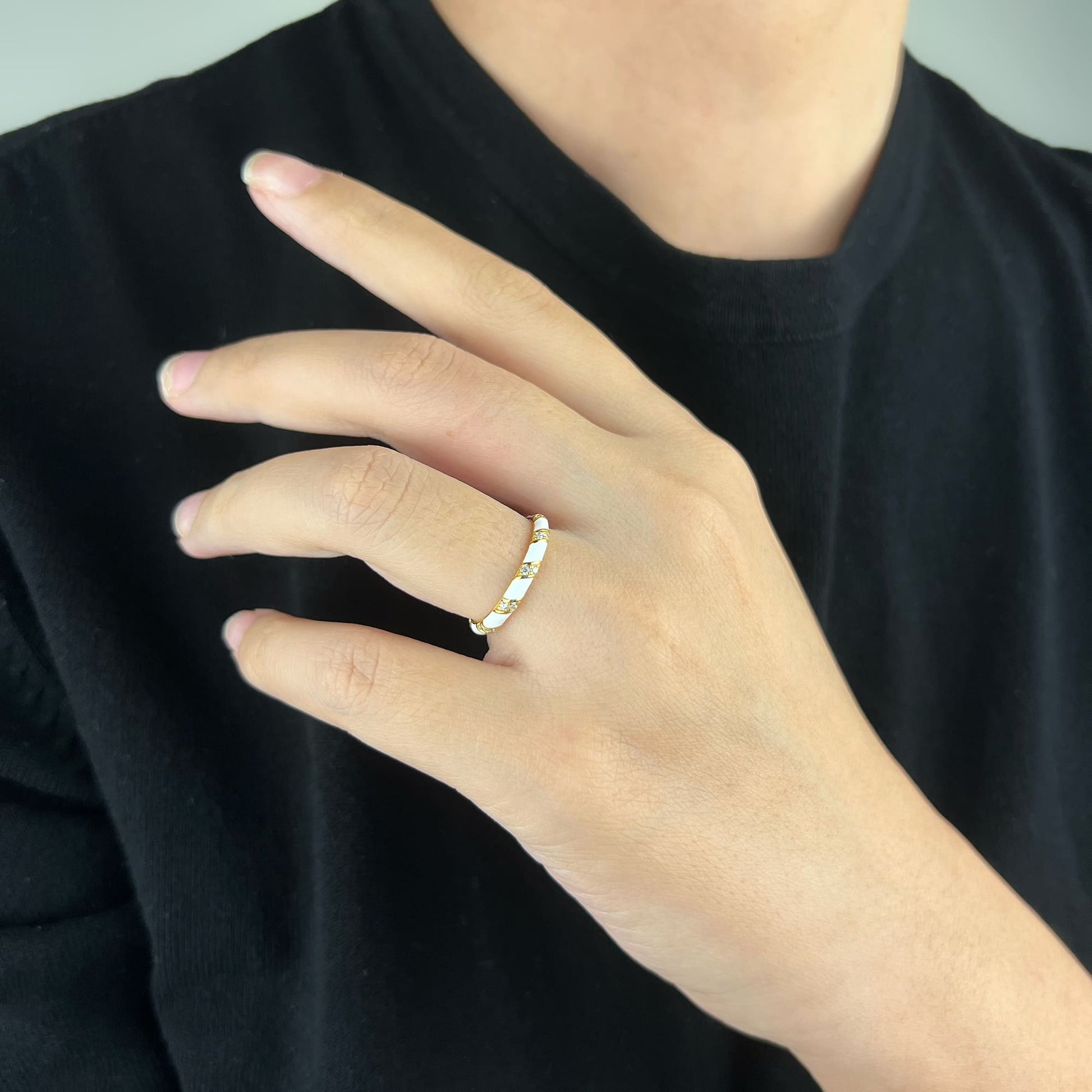 Model wearing the versatile Enamel Spiral Ring - Effortlessly balancing casual elegance and opulent glamour with its timeless spiral design, making it the perfect accessory for any occasion.