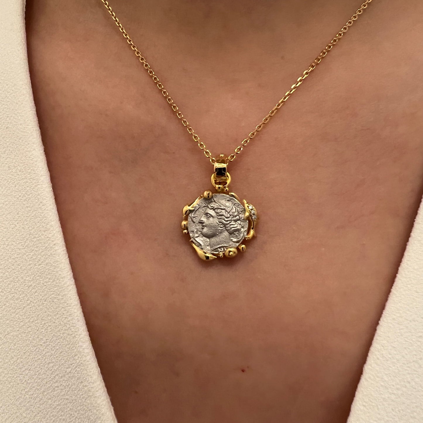 Model wearing the Nymph Arethusa Coin Necklace, showing the front view of the ancient Greek coin pendant featuring the graceful nymph Arethusa.