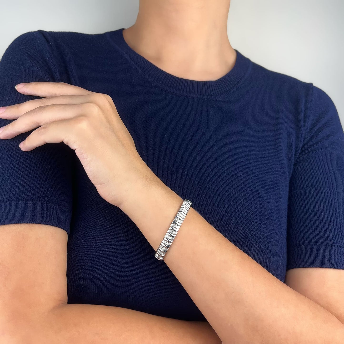 Model flaunting the Half Pave Twisted Silver Bracelet - Impressively crafted with a perfect blend of firmness and flexibility, offering seamless joints and a comfortable fit. Experience refined elegance with a touch of luxury and sophistication.