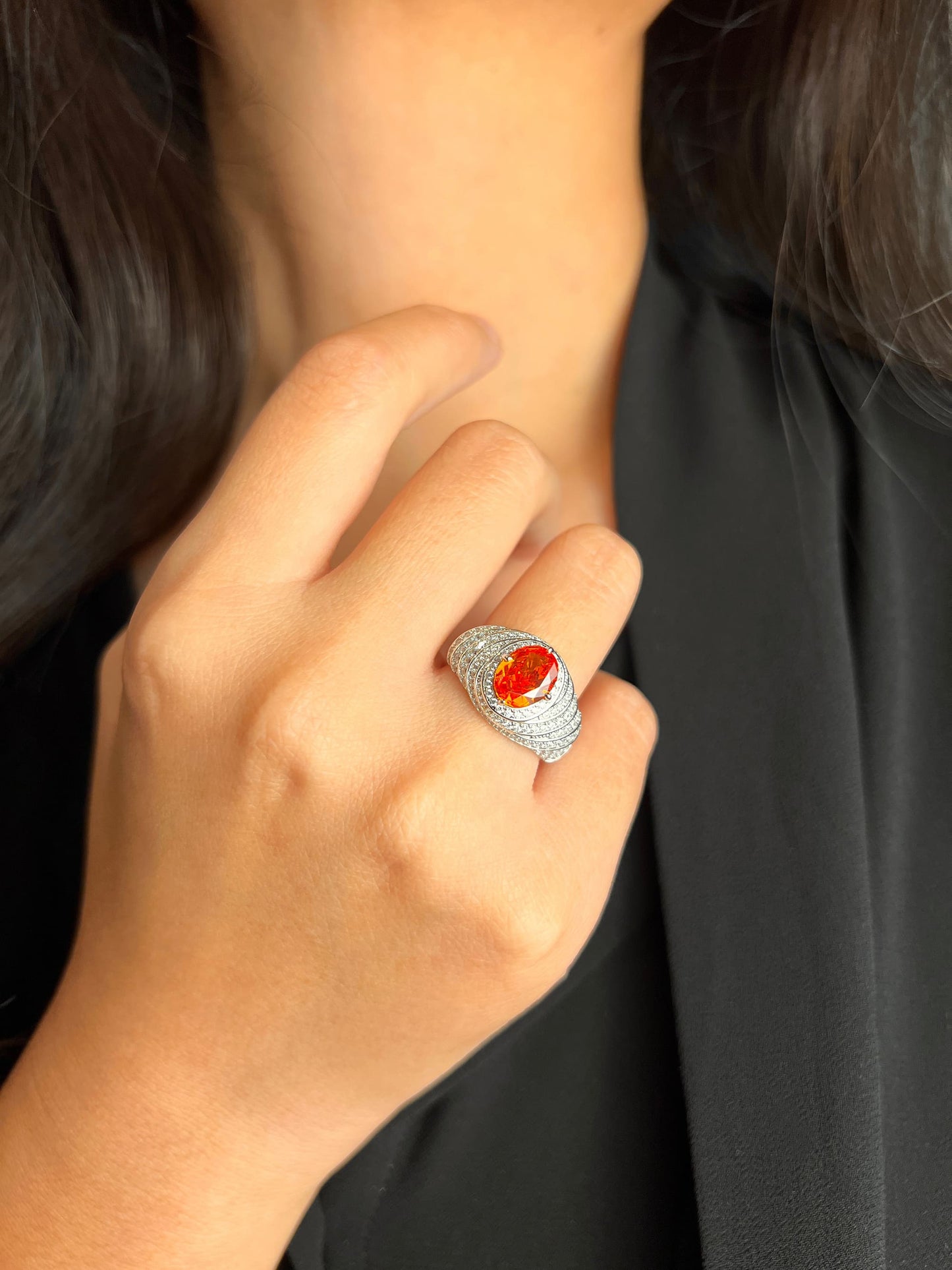 Close-up of Mandarin Garnet Spiral Ring with brilliant simulated diamonds