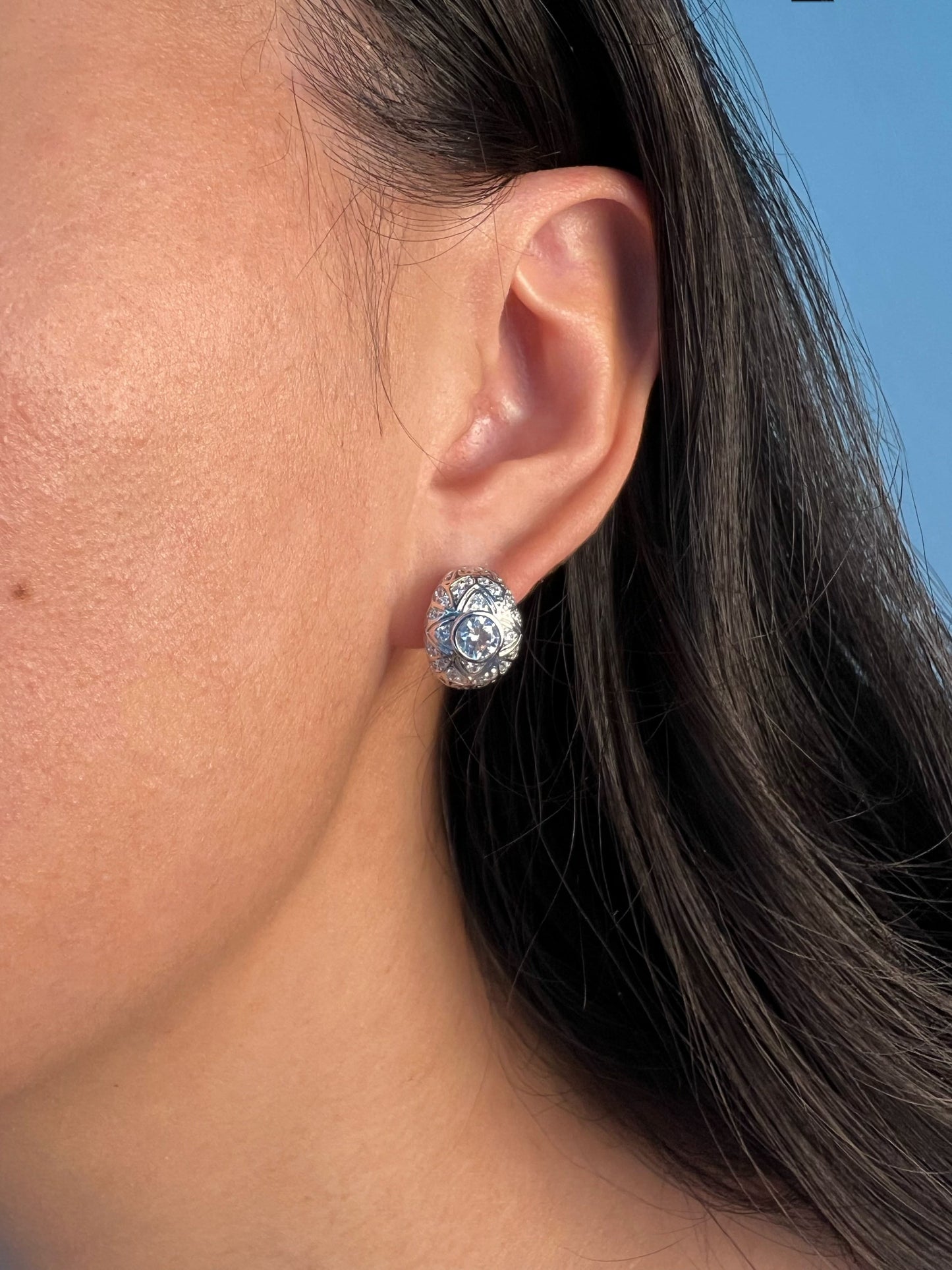 Experience elegance with Quatrefoil Earrings as they gracefully adorn a model, adding a touch of vintage charm to any ensemble.