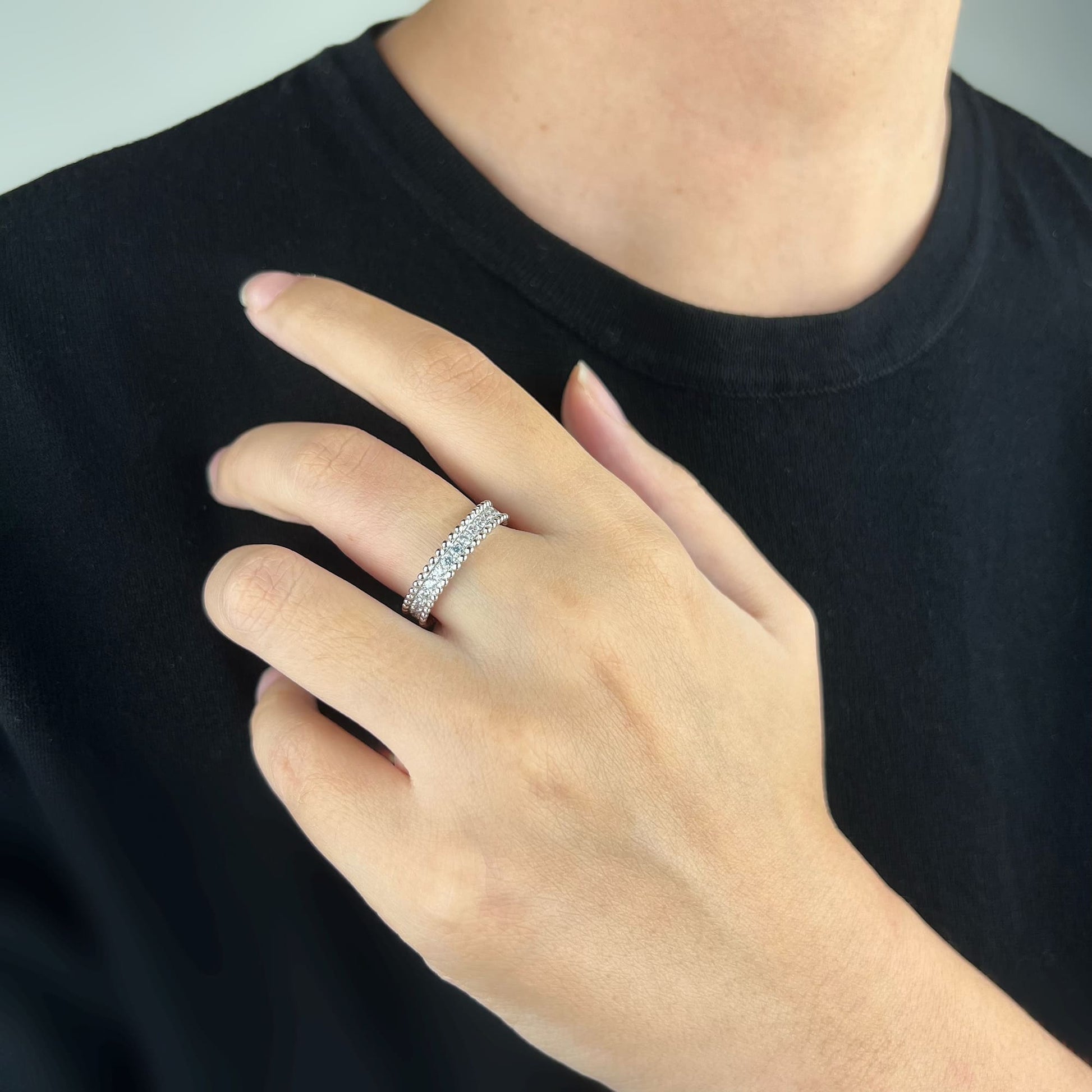 Model wearing the Orbit Ring in Silver - Sleek and stylish, featuring finely crafted ball-shaped edges and simulated diamonds for a touch of refined simplicity.