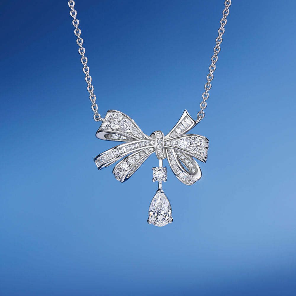 A detailed shot of the Belle Bow Necklace in silver, highlighting its polished finish and fine craftsmanship.